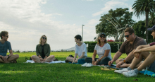 Students Outdoor in Group Discussion on Grass