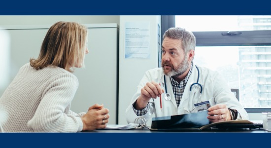 Doctor and patient talking in a office.