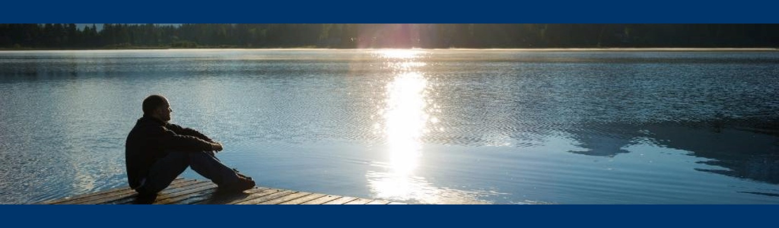 Image of a man pondering a sunset