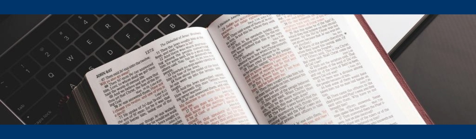 Image of a bible open on a keyboard