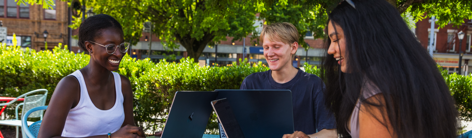 Students on computers outside