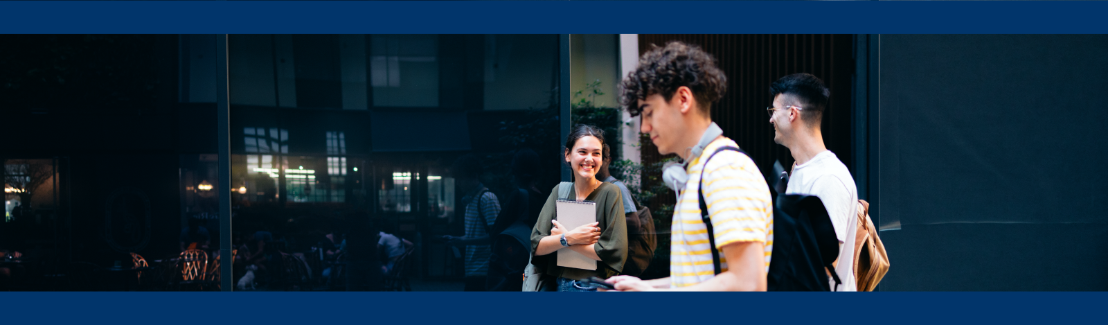 Three high school students walking outside