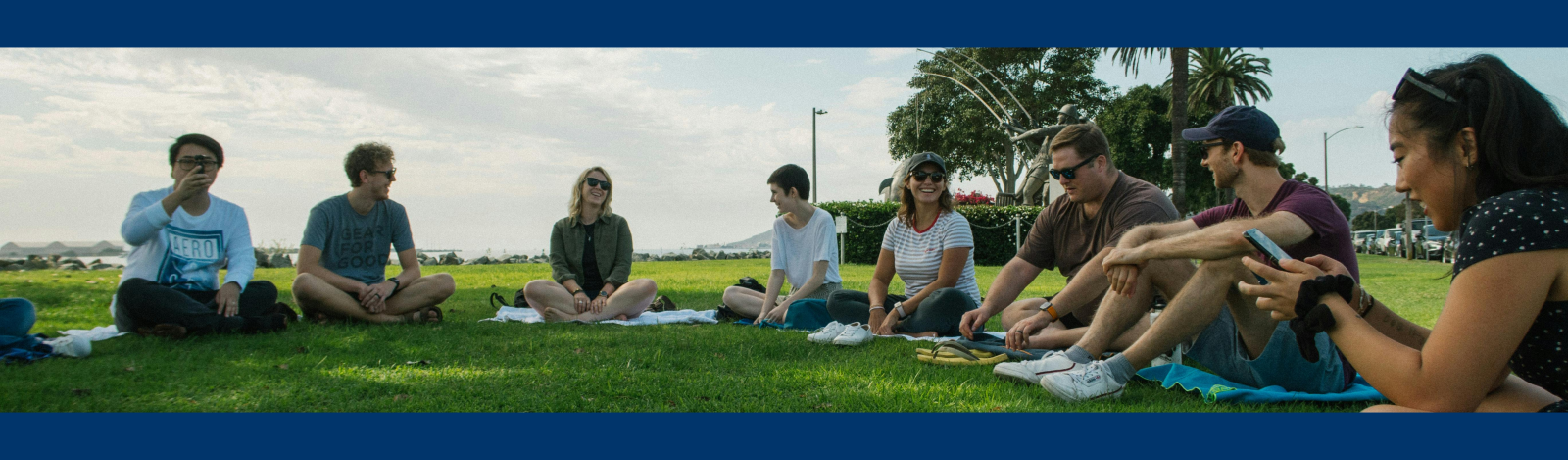 Youth Ministry Students sitting in a semi-circle outside