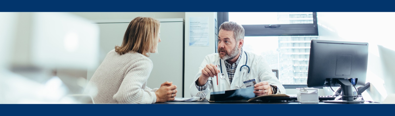Doctor and patient talking in a office.