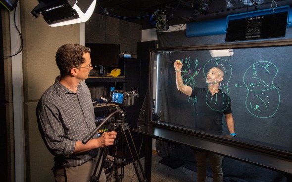 Behind the scenes of filming at broadcast, people in sessions with cameras 