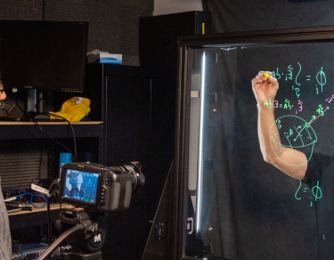 Video editor and faculty member in filming studio.