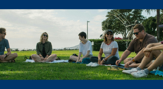 Youth Ministry Students sitting in a semi-circle outside